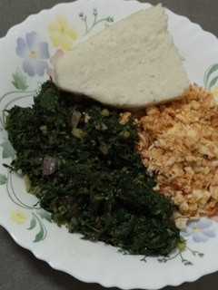 A picture of Ugali, Sukuma wiki with scrambled eggs.