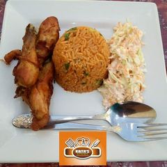 Jollof rice with coleslaw and chicken A picture of Jollof rice with coleslaw and chicken.