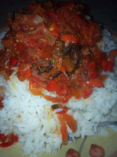 A picture of Rice and tomatoes sauce.