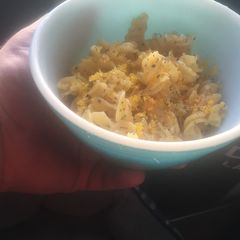 A picture of Garlic basil pasta with cured egg yolk.