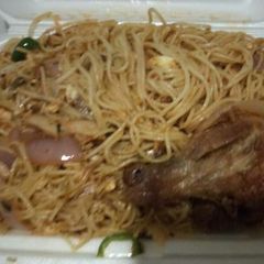 A picture of Jollof spaghetti with chicken.
