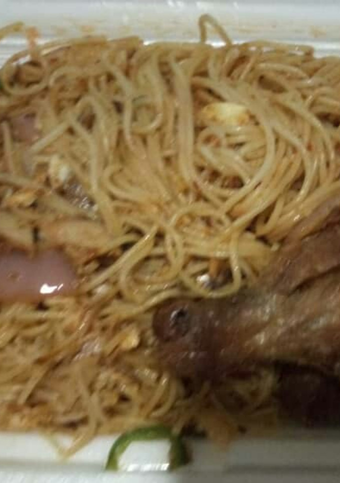 A picture of Jollof spaghetti with chicken.