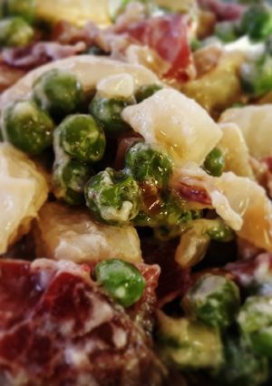Una foto de Guisantes y patatas salteados con jamón y ajos tiernos