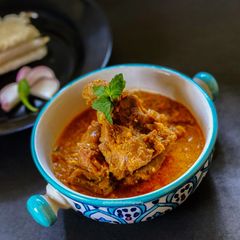 A picture of Mutton Saaru with Neer Dosa.