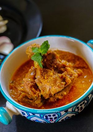 A picture of Mutton Saaru with Neer Dosa.