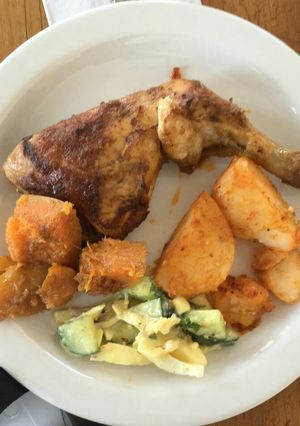 A picture of Grilled chicken with veggies.