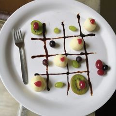 A picture of Rasgulla with fruits.