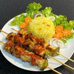 Chicken shashlik with vegetable fried rice A picture of Chicken shashlik with vegetable fried rice.