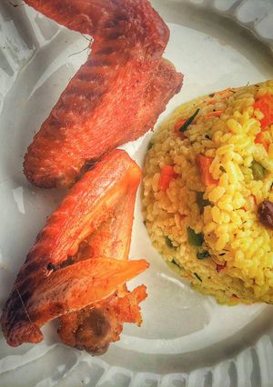A picture of Fried rice and chicken.