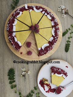 A picture of Mango cake with raspberry sauce.