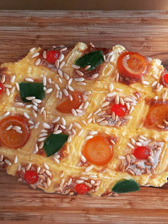 Una foto de Coca de Sant Joan de crema, piñones y frutas confitadas