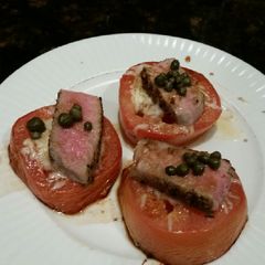 A picture of Brad's cheesey tomatoes with seared ahi tuna and capers.