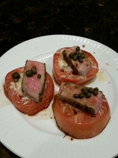 A picture of Brad's cheesey tomatoes with seared ahi tuna and capers.