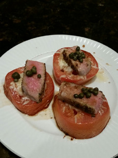 A picture of Brad's cheesey tomatoes with seared ahi tuna and capers.