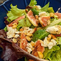 A picture of Figs and mozzarella cheese salad with balsamic dressing.
