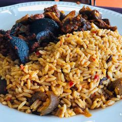 A picture of Jollof rice with snail and pomo.
