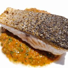 A picture of Pan-fried salmon with fresh tomato pesto.