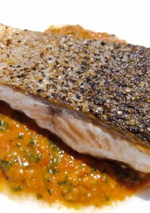A picture of Pan-fried salmon with fresh tomato pesto.