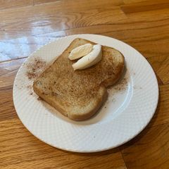 A picture of Toast with cinnamon and whip cream on it (^^).