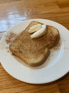 A picture of Toast with cinnamon and whip cream on it (^^).