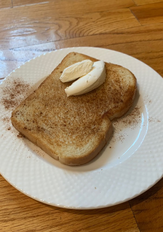 A picture of Toast with cinnamon and whip cream on it (^^).