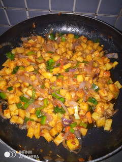 A picture of Potatoes with veggies.