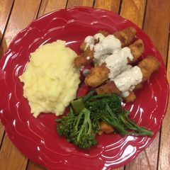 A picture of ParmFish fingers served with creamy mash and assorted vegetables.