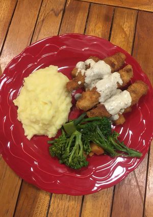 A picture of ParmFish fingers served with creamy mash and assorted vegetables.