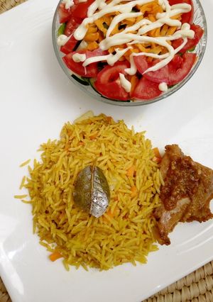 A picture of Long grain fried rice with salad.