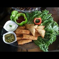 A picture of Chicken Samosa and roll.