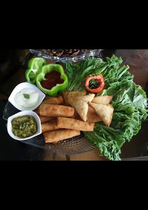A picture of Chicken Samosa and roll.