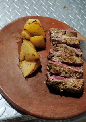 A picture of Beef Steak with Parsley and Rustic Potatoes.
