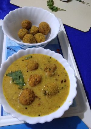 A picture of Coconut Kadhi with chana dal dumplings.
