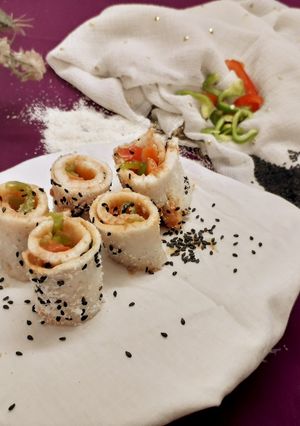 A picture of Dhokla sushi with Bell peppers.