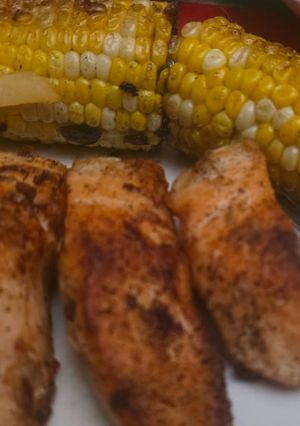 A picture of Garlic butter salmon with corn on the cob.
