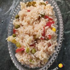 A picture of Vegetable pulao with sweet corn.
