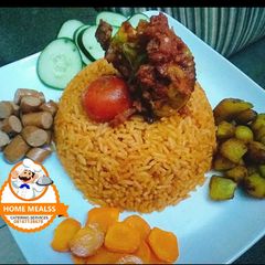 Jollof rice with boiled carrot,and grilled Chicken A picture of Jollof rice with boiled carrot,and grilled Chicken.