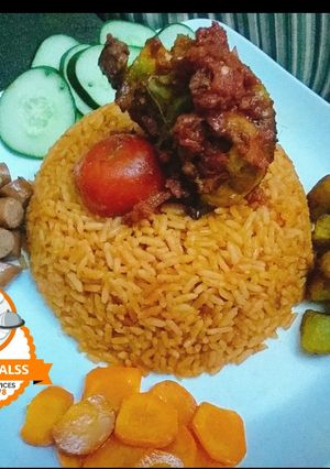 A picture of Jollof rice with boiled carrot,and grilled Chicken.