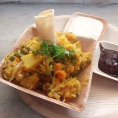 A picture of Veg khichdi with curd and sweet sour mango pickle.