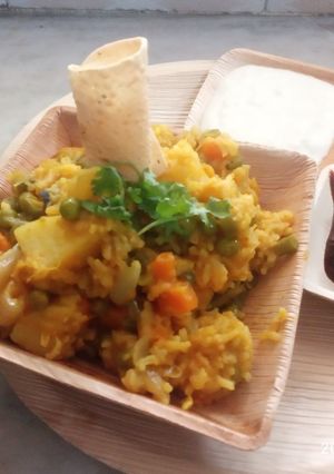 A picture of Veg khichdi with curd and sweet sour mango pickle.