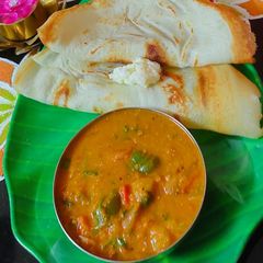 A picture of Dosa with Spicy Onion Curry.