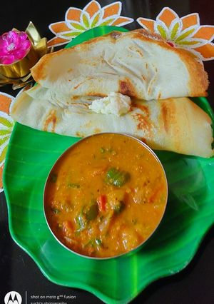 A picture of Dosa with Spicy Onion Curry.