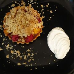 A picture of Nectarine, Raspberry, Polenta and Almond crumble tart.