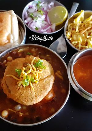 A picture of Misal Pav with spicy Tari.