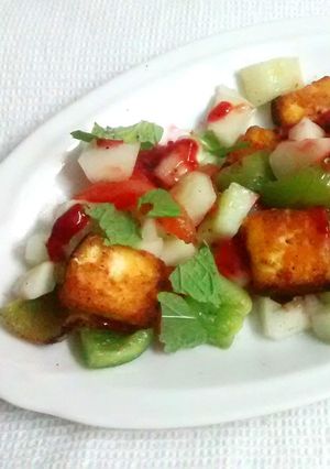 A picture of Grilled Paneer and vegetable salad with strawberry puree.