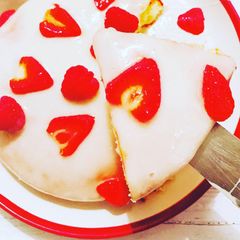 A picture of Sponge cake topped with greek yogurt and strawberry icing.