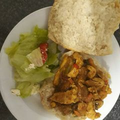 Chicken stir fry, panini bread with green salad A picture of Chicken stir fry, panini bread with green salad.