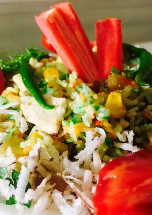 A picture of Mix veg briyani with grated coconut.