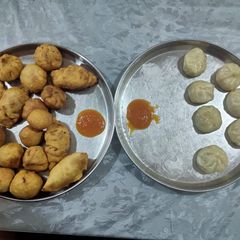 A picture of Momos- Fried and steamed with momo chutney.