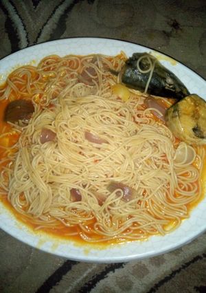 A picture of Spaghetti jollof with fish.